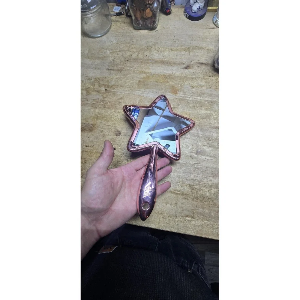 Jeffree Star Cosmetics Rose Gold Chrome Star Hand Mirror.